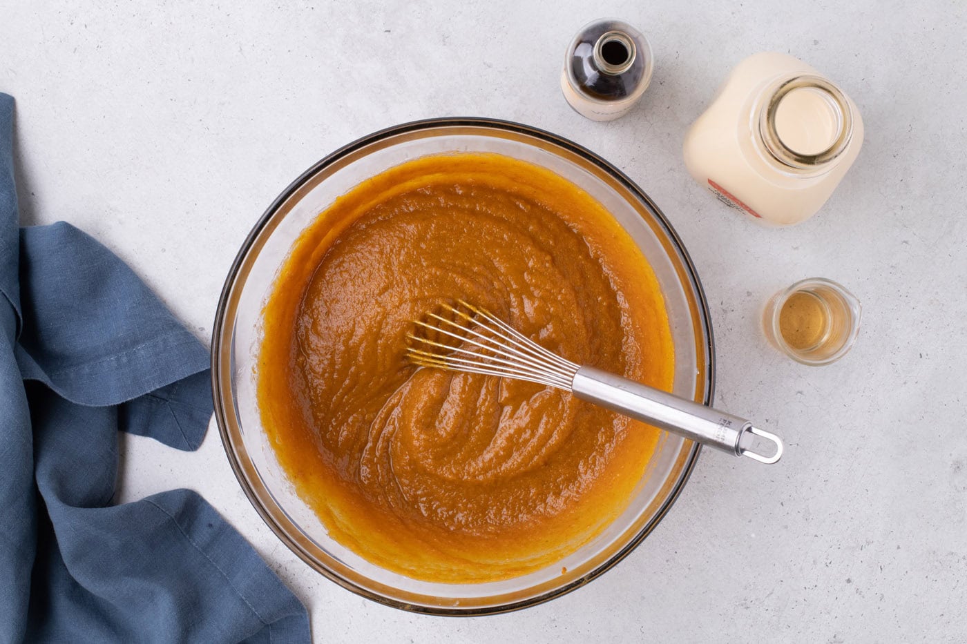 pumpkin pie filling in a bowl with a whisk