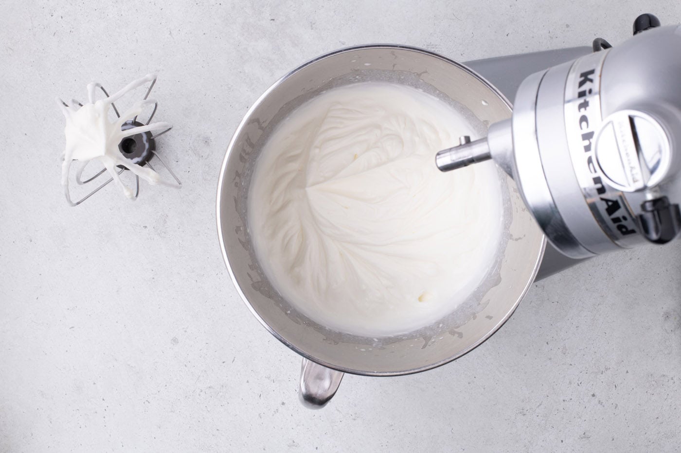 fresh whipped cream in a bowl of a stand mixer