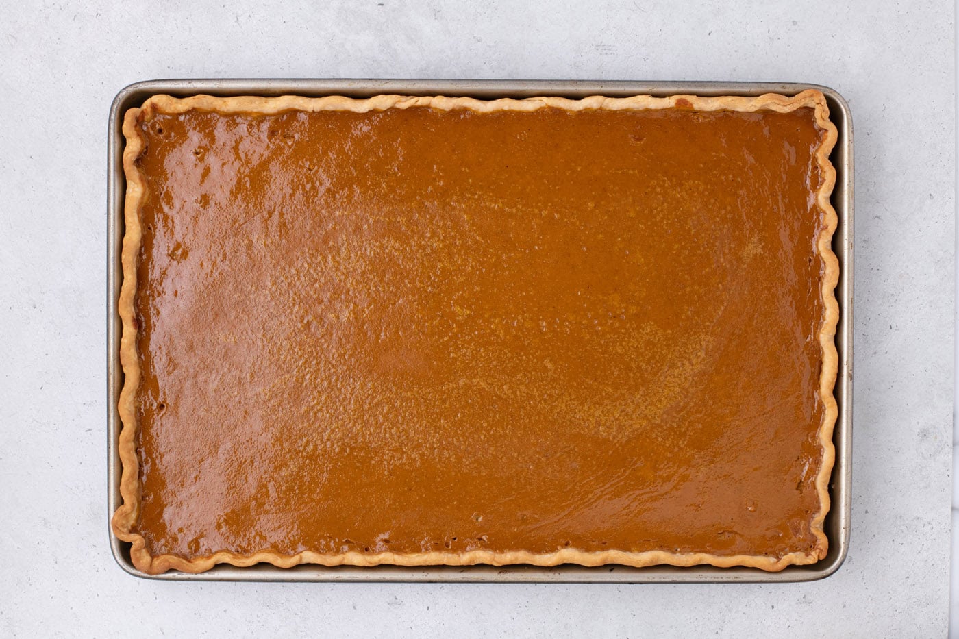 baked pumpkin slab pie in a jelly roll pan