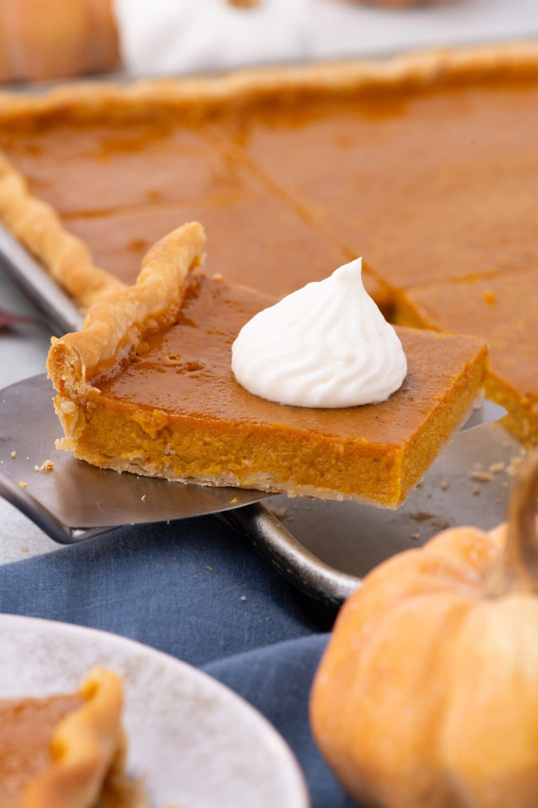 Slice of Pumpkin Slab Pie on a spatula 