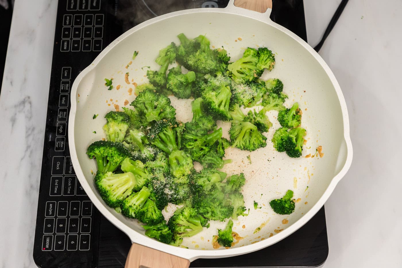 broccoli florets in a skillet with garlic