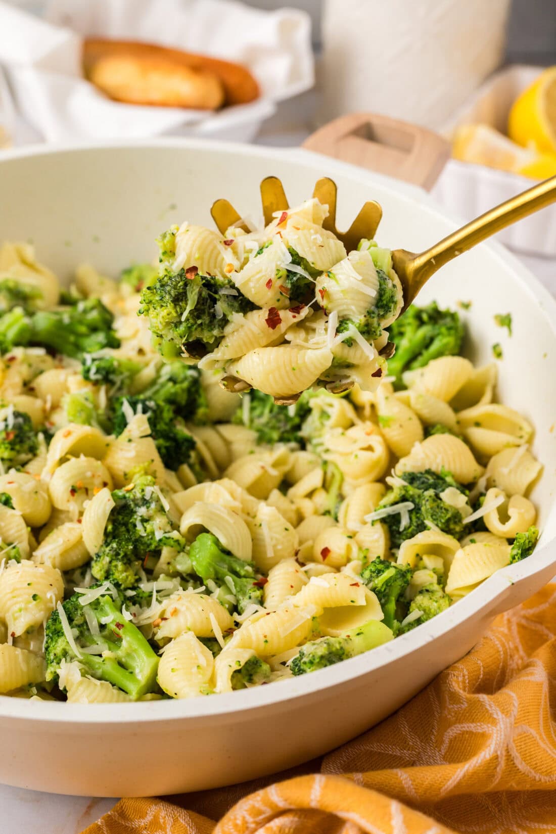 Serving spoon in a skillet of Broccoli Pasta