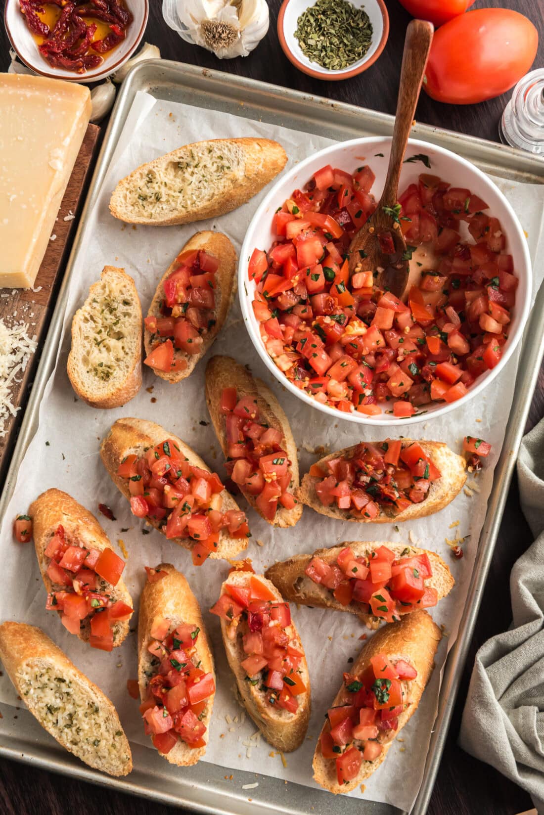 Pan of Bruschetta with a bowl of Bruschetta to the side