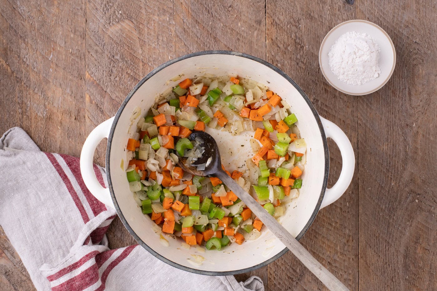 sauteed veggies in a Dutch oven sprinkled with seasonings