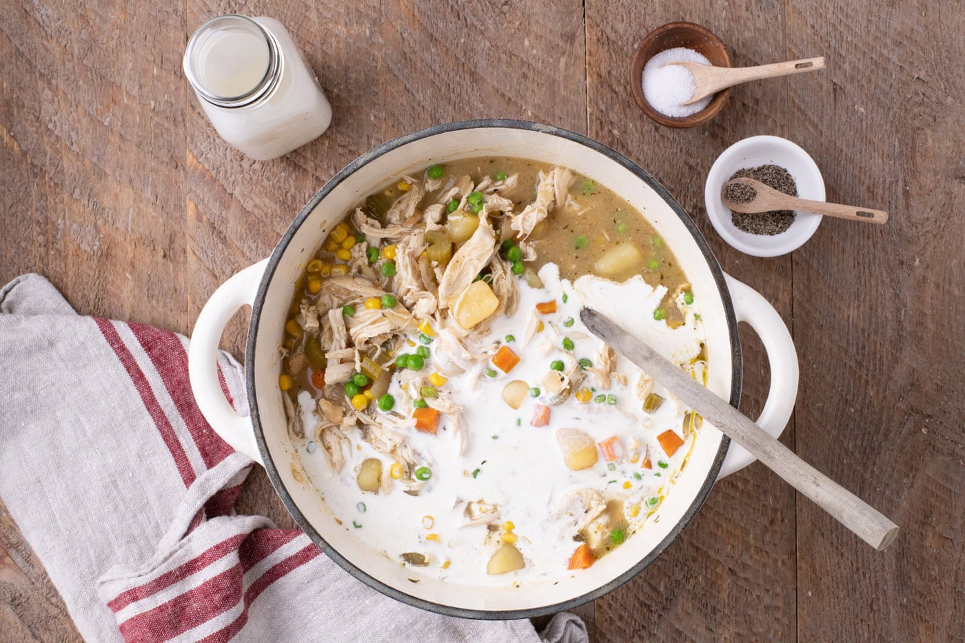 heavy cream added to chicken pot pie soup in a Dutch oven