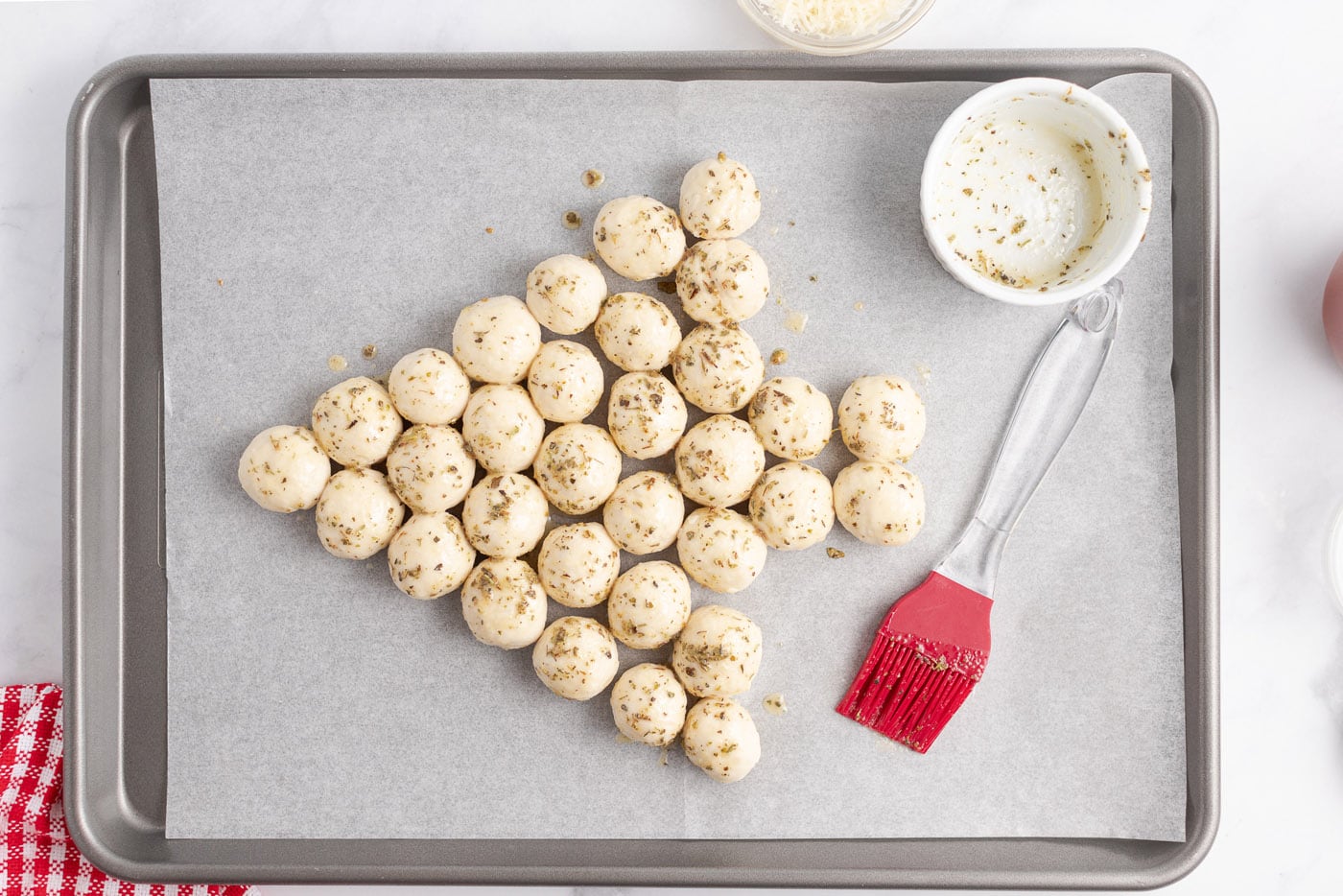 Butter mixture brushed on top of the dough balls