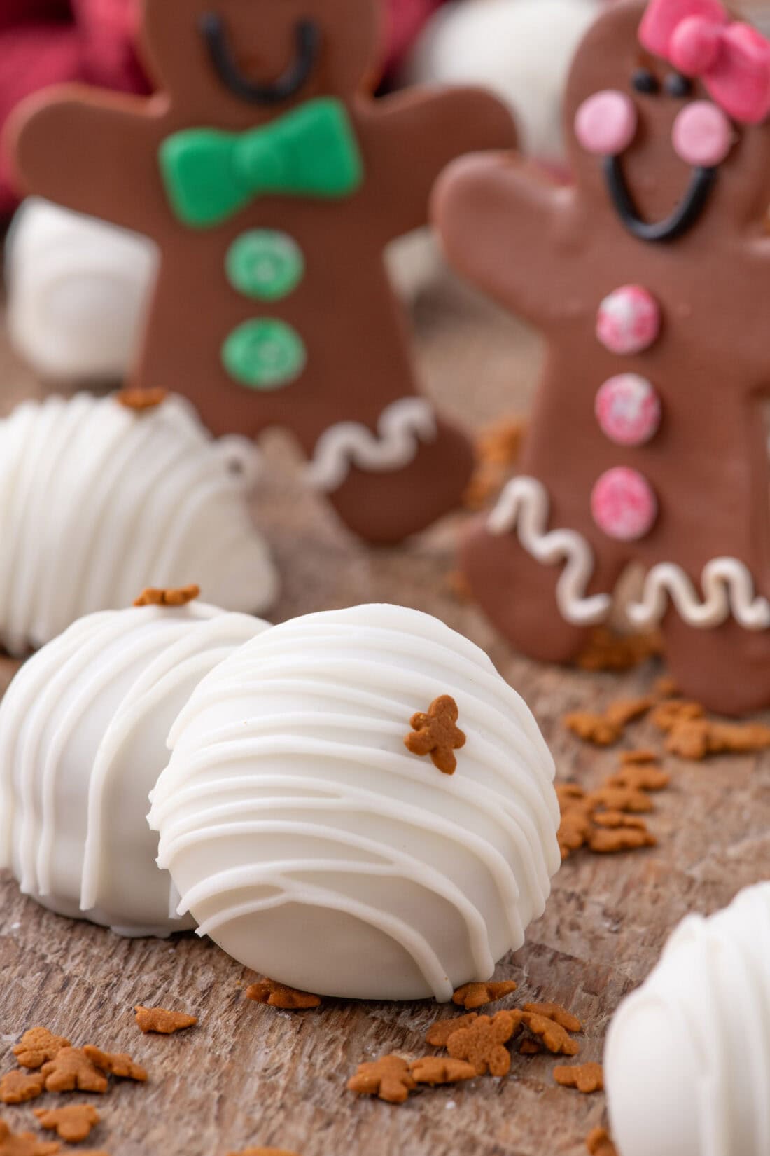 Close up photo of a Gingerbread Oreo Truffle with gingerbread cookies in the background