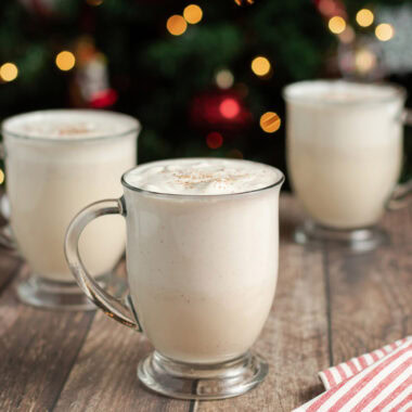 Close up photo of three mugs full of Homemade Eggnog