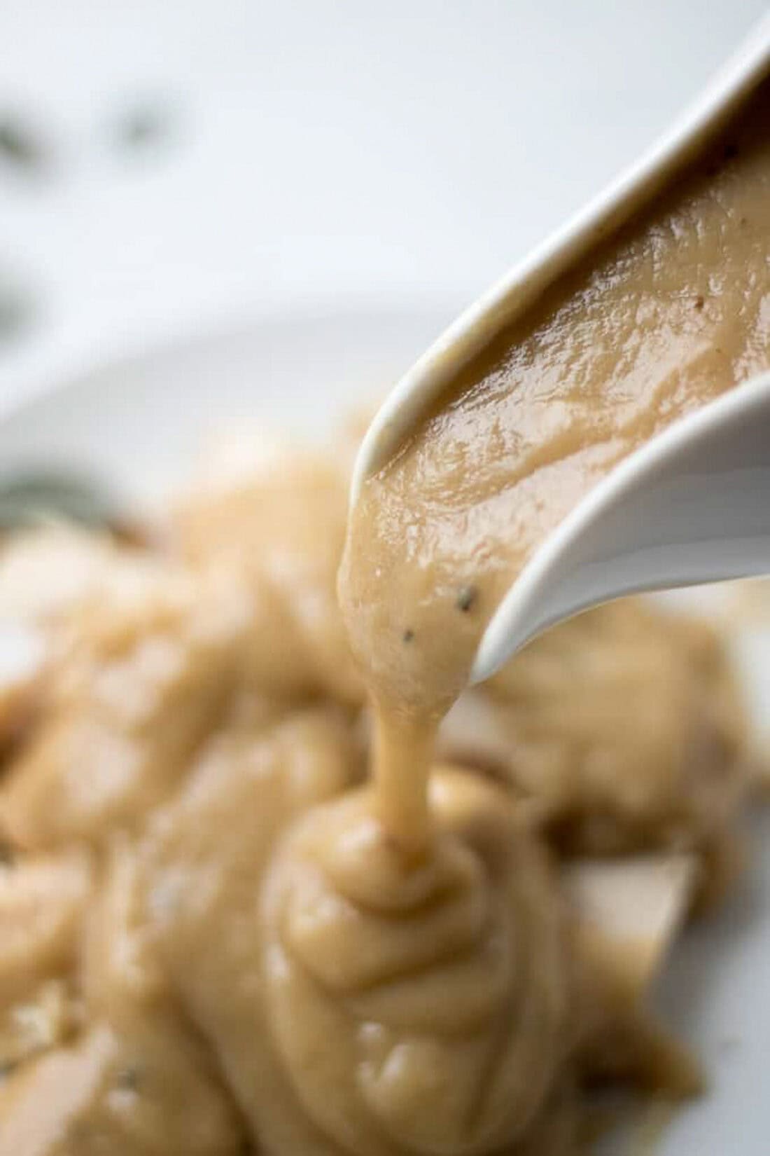 Homemade Turkey Gravy pouring out of a gravy boat