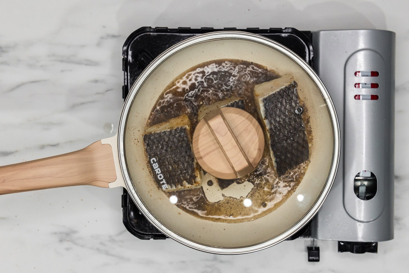 lid on skillet over chilean sea bass