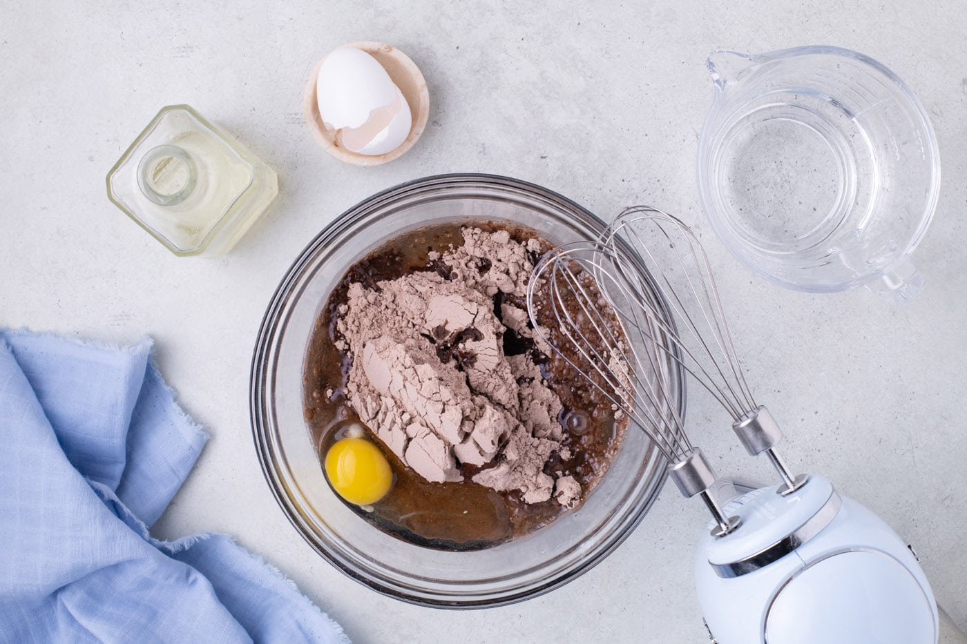 cake mix with oil and eggs in a bowl with a whisk