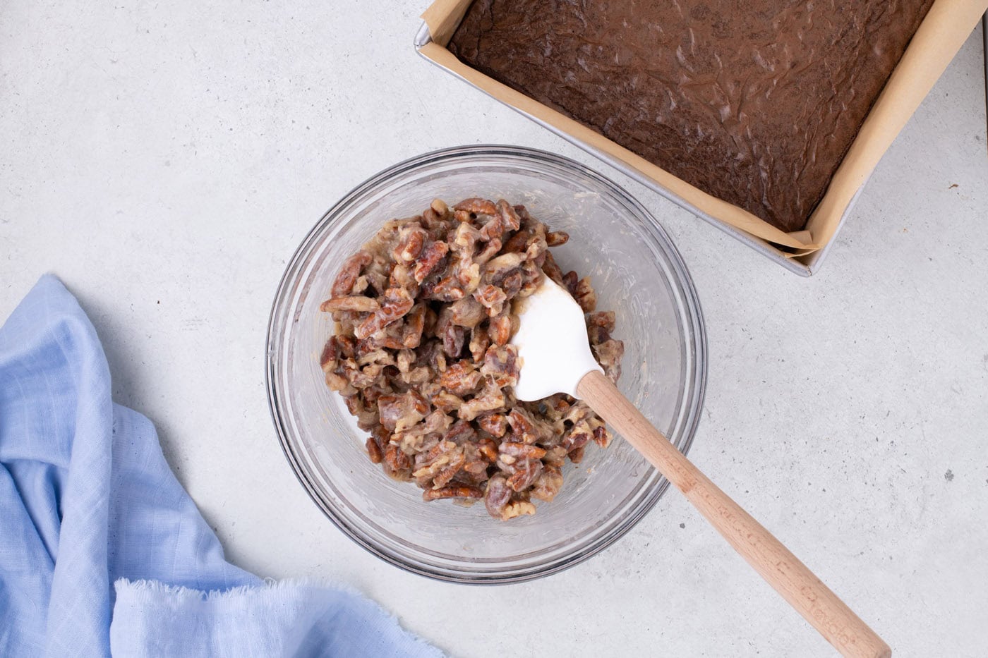 pecan pie topping mixed in a bowl with a rubber spatula