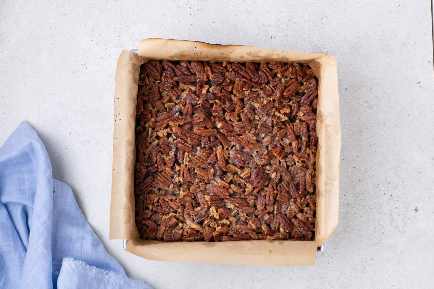 baked pecan pie brownies in a baking pan