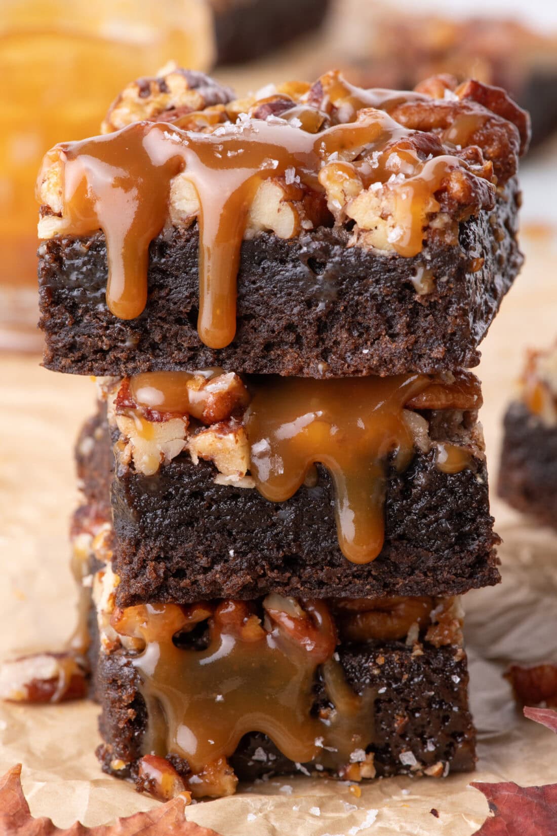 Stack of three Pecan Pie Brownies with caramel drizzled on top