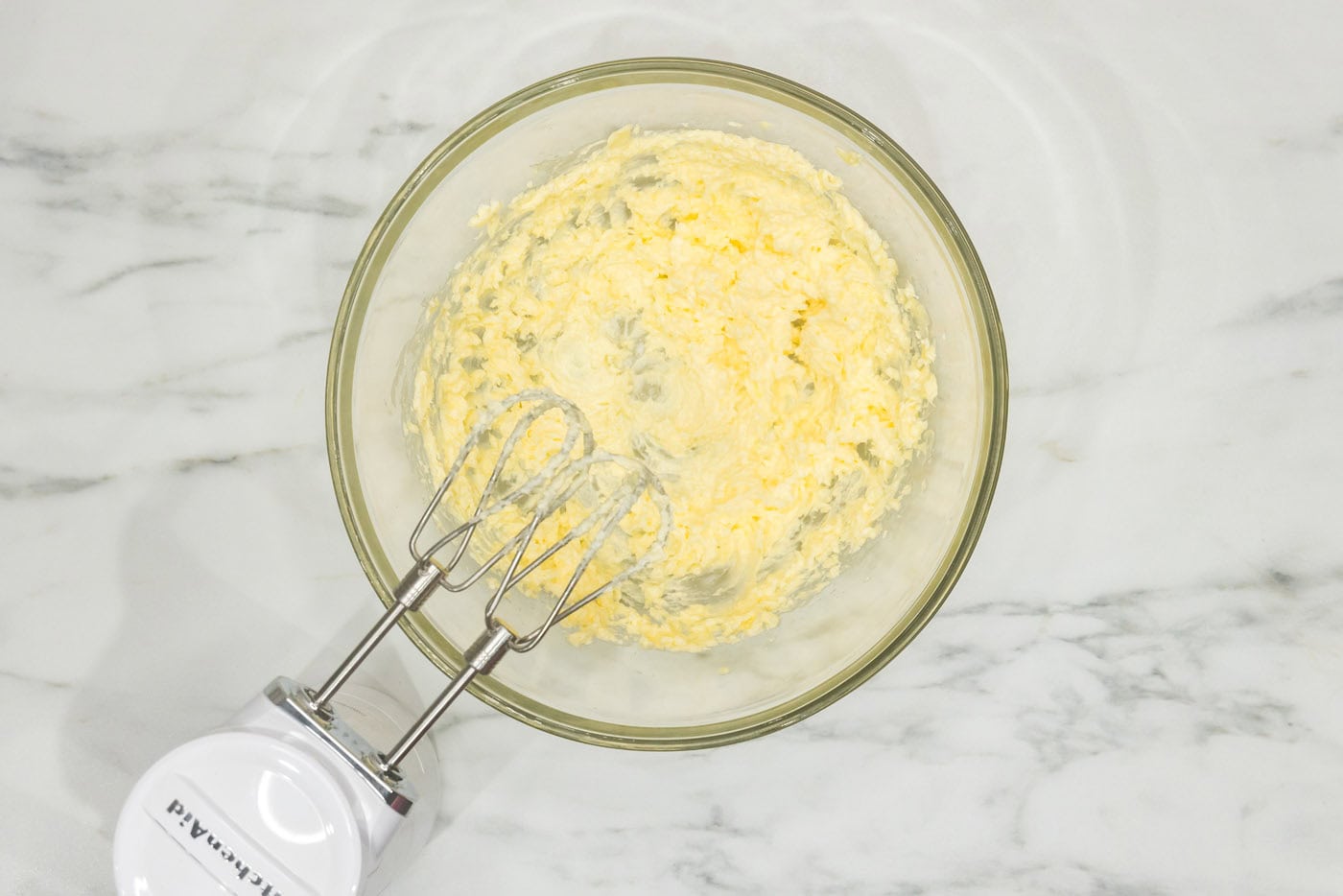 hand mixer beating together butter and shortening