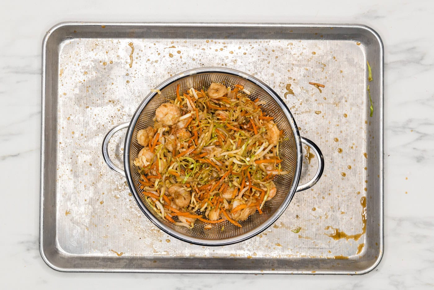 egg roll filling draining in a colander