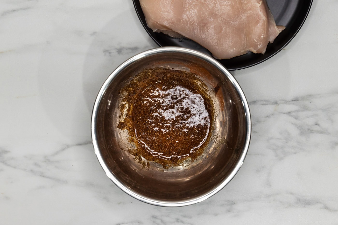 olive oil mixed with spices and seasonings in a bowl