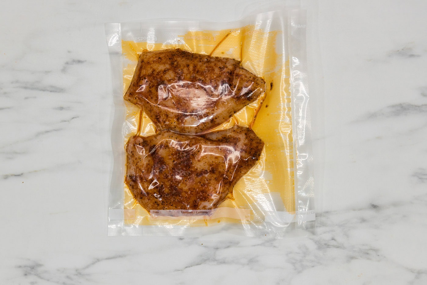 seasoned chicken breast in a vacuum sealed bag