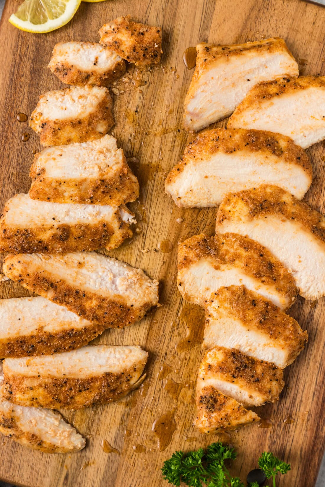 Close up photo of slices of Sous Vide Chicken Breast on a wooden board