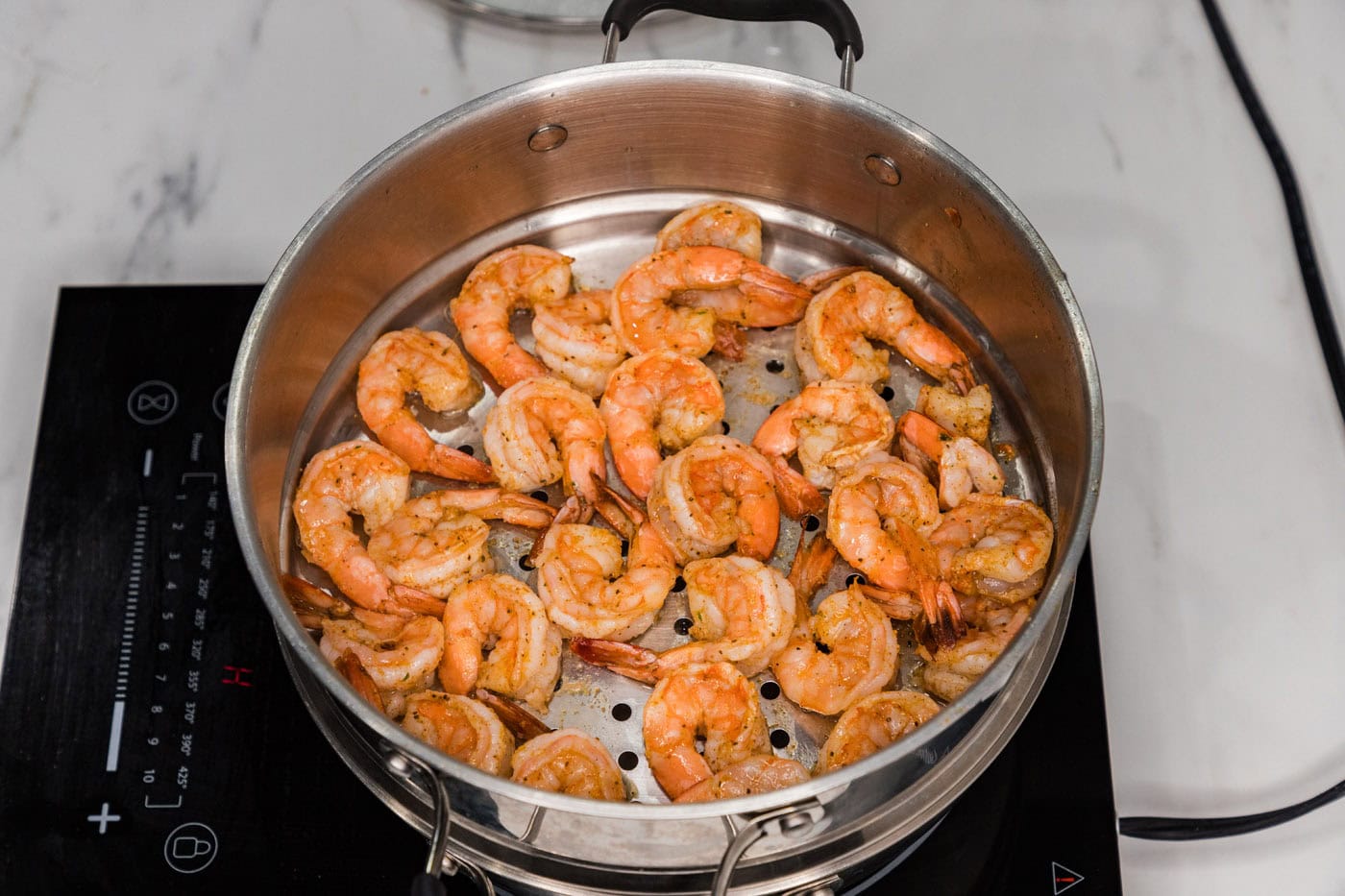 cooked steamed shrimp in steamer basket