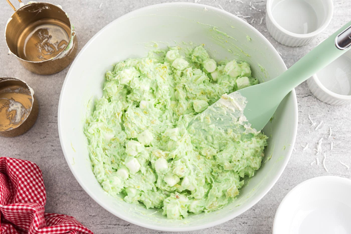 watergate salad in a bowl with a rubber spatula