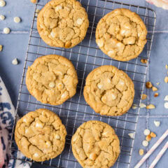 Close up photo of White Chocolate Macadamia Nut Cookies cooling on a wire rack