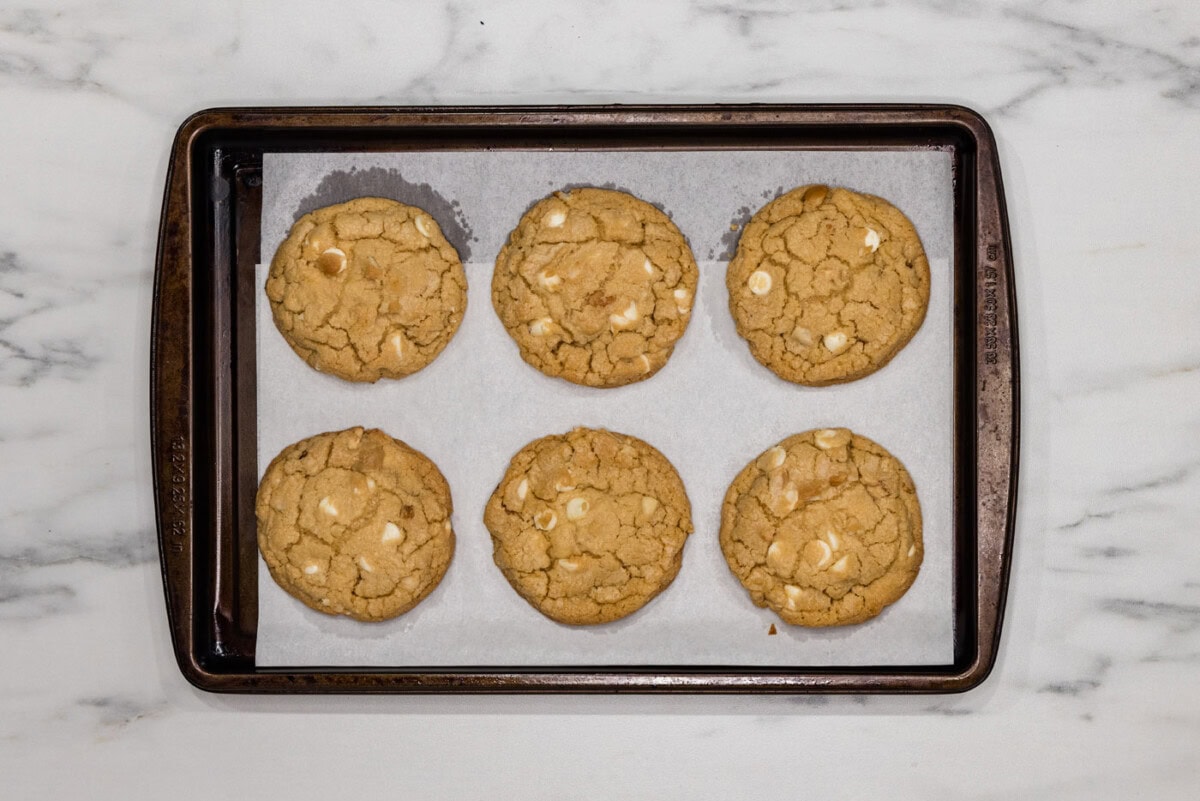 baked white chocolate macadamia nut cookies on a baking sheet