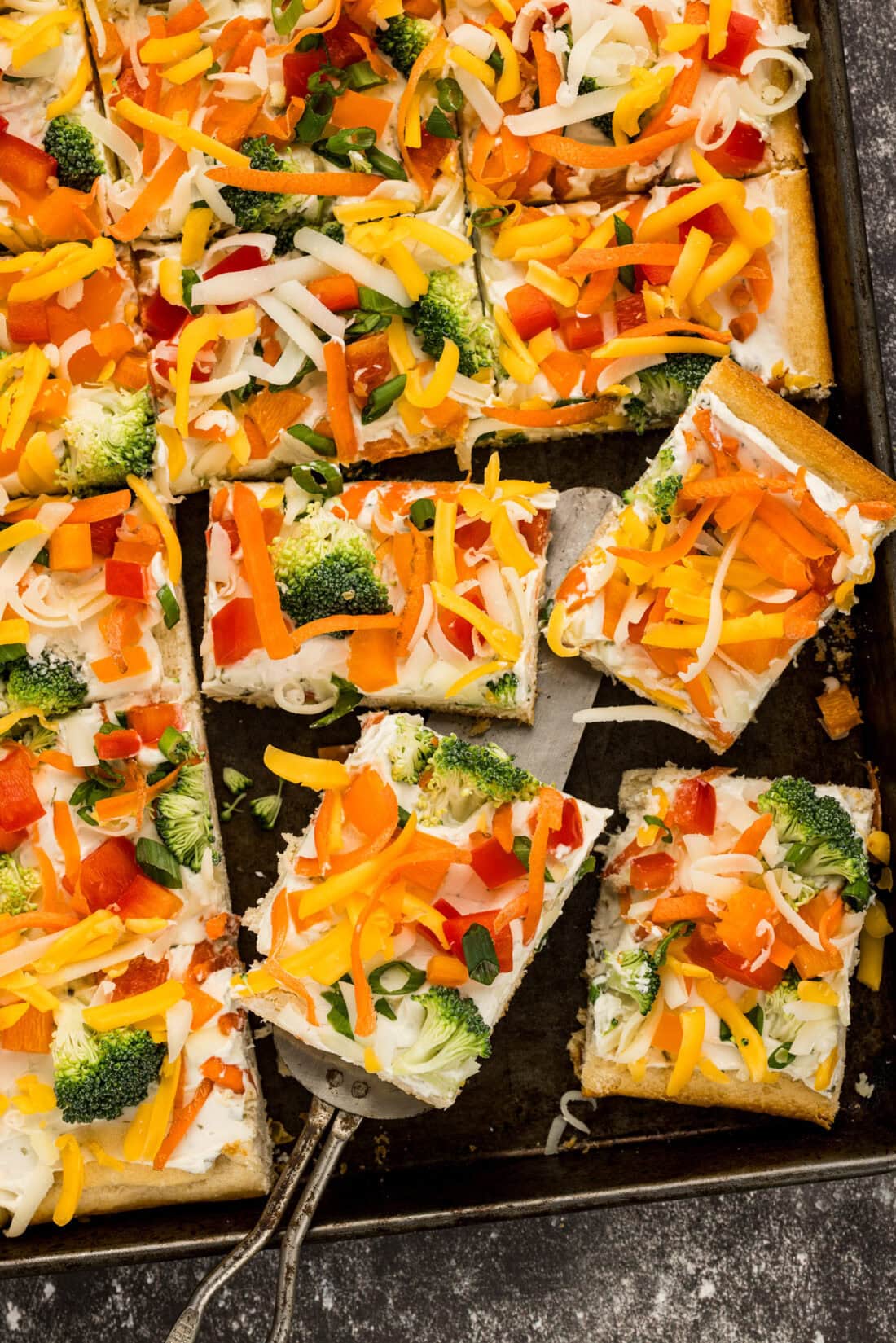 Close up photo of Appetizer Veggie Pizza slices on a pan