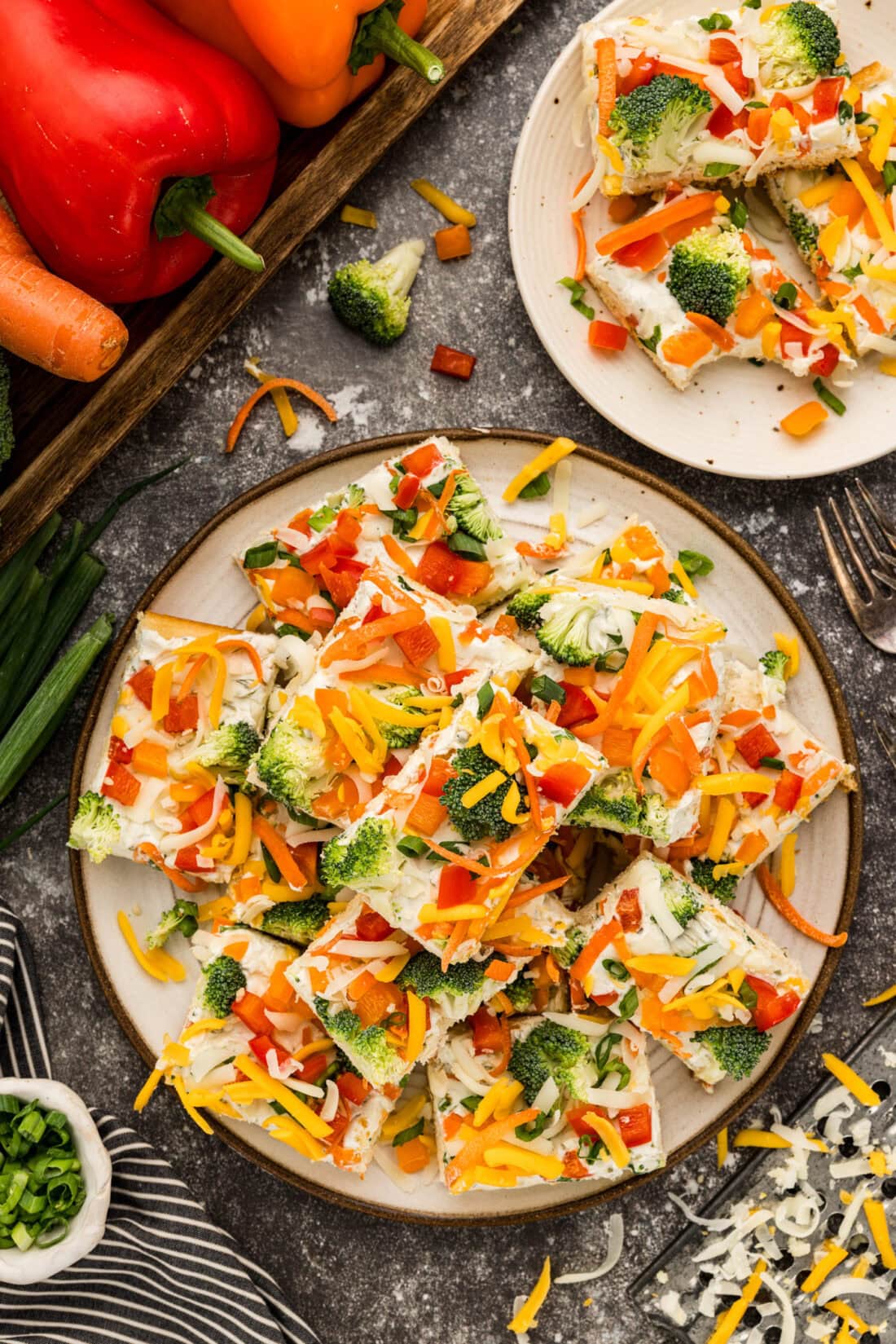 Appetizer Veggie Pizza slices piled on a plate