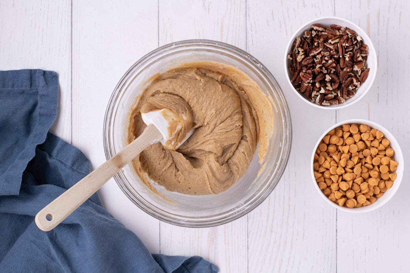 blondies batter in a mixing bowl with a rubber spatula