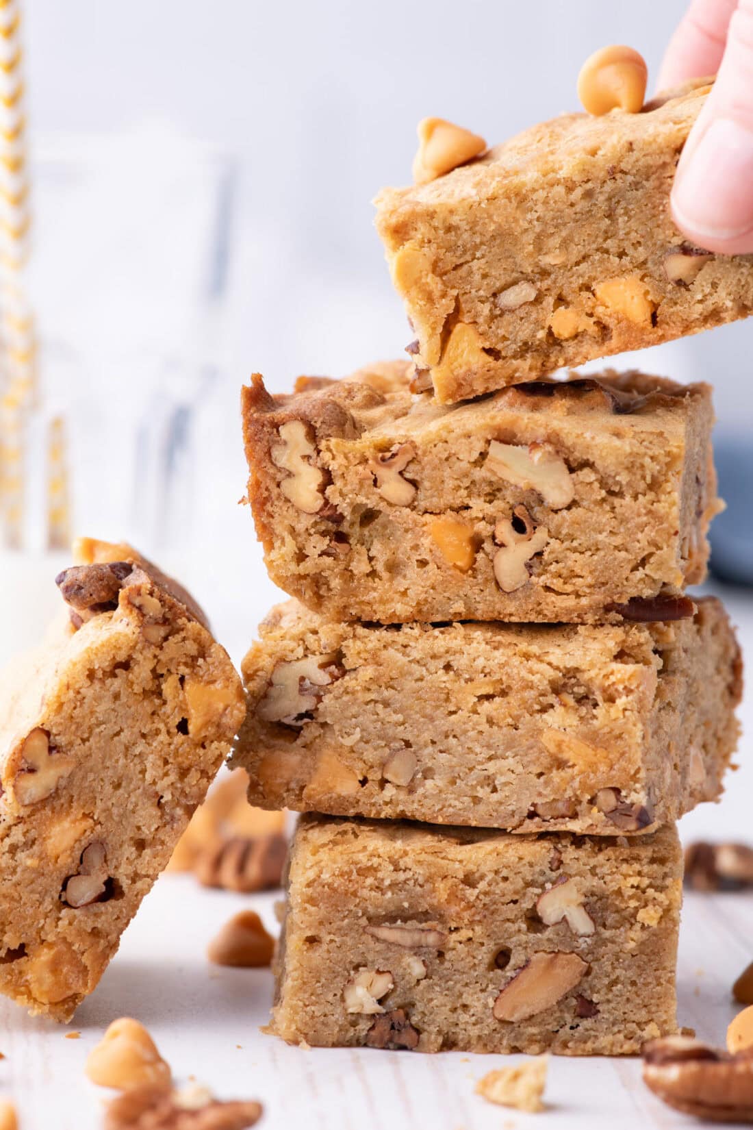 Hand grabbing a Butterscotch Brownie off a stack of brownies