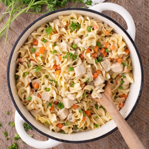 Close up photo of a pot of Chicken Pot Pie Pasta with a spoon in it