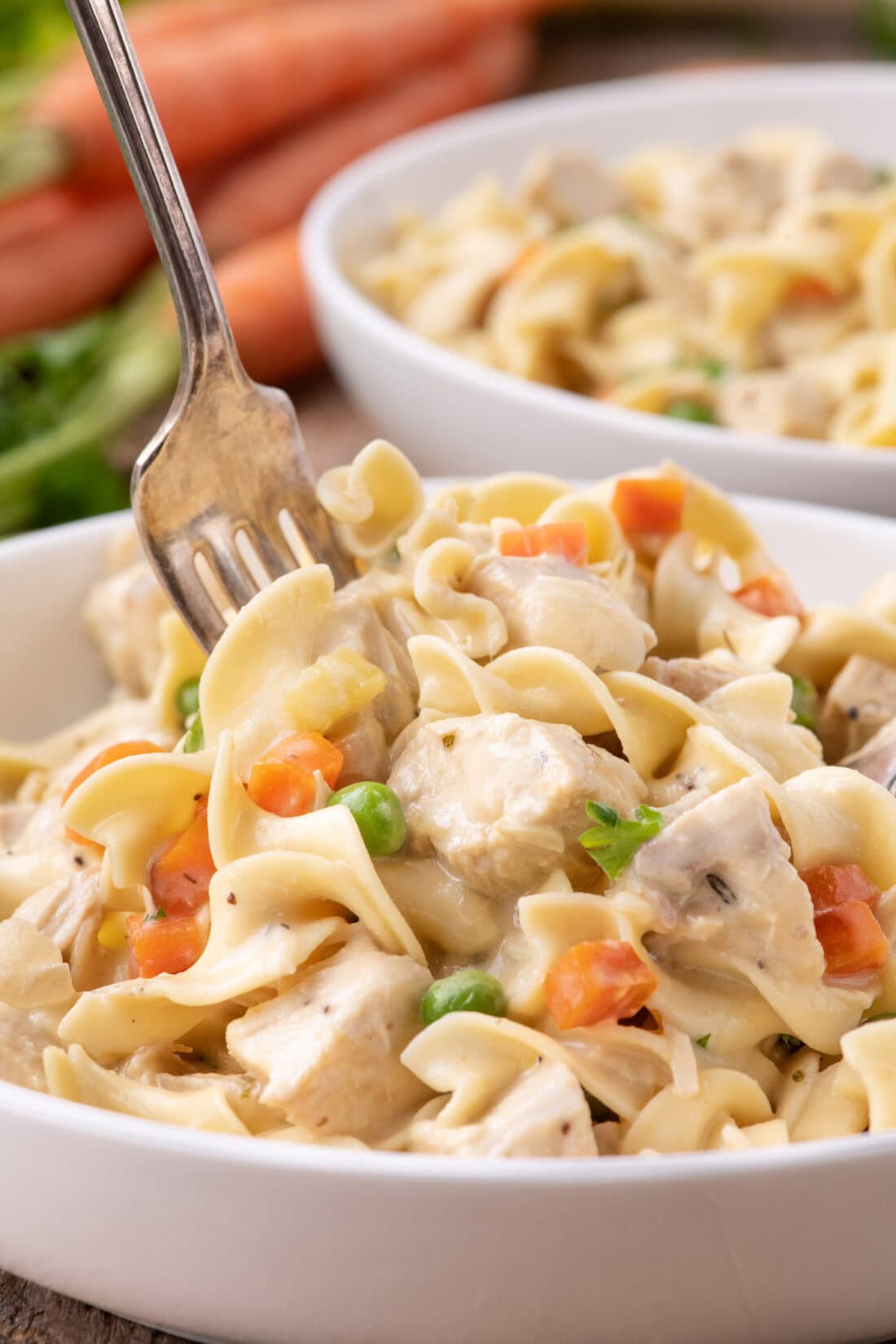 Fork digging into a bowl of Chicken Pot Pie Pasta