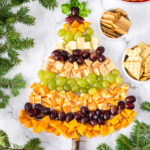 Overhead photo of a Christmas Tree Cheese Platter with crackers on the side