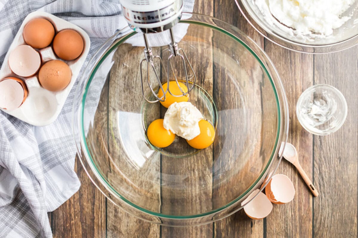 Cream cheese and egg yolks in a bowl