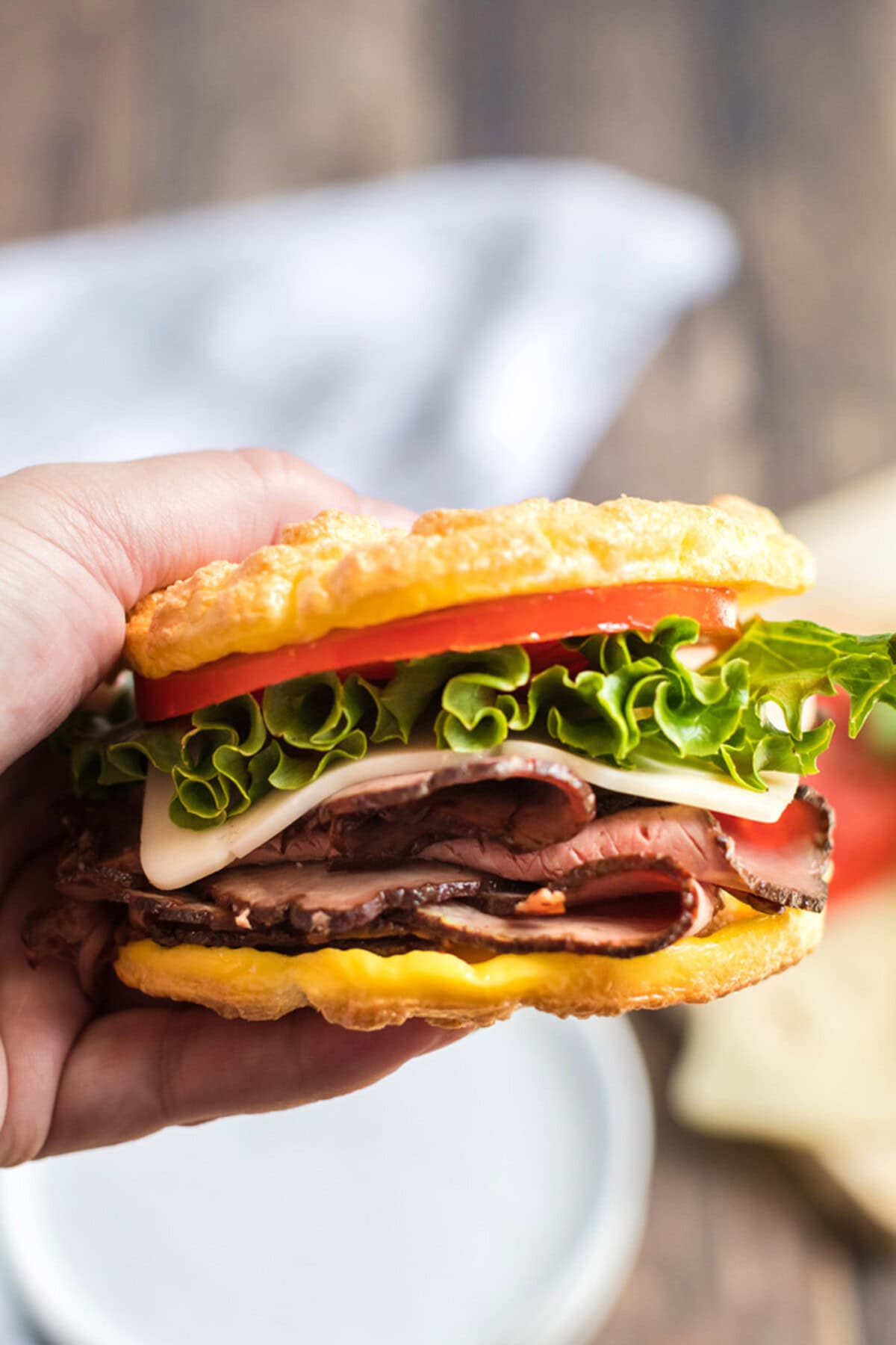 Hand holding a sandwich made with Cloud Bread