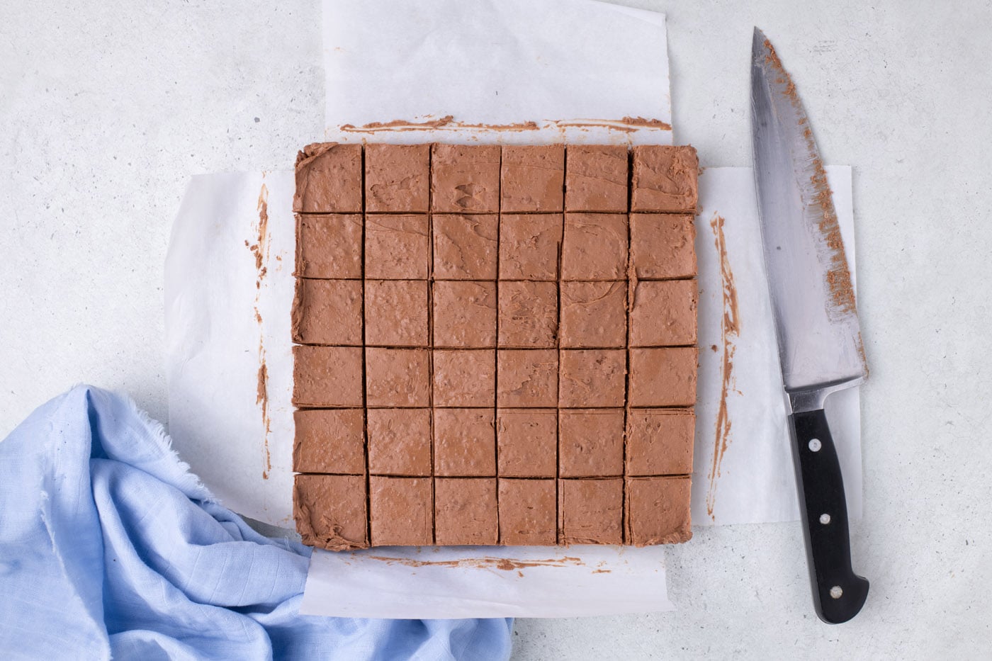 whipped chocolate sliced into squares in a baking pan