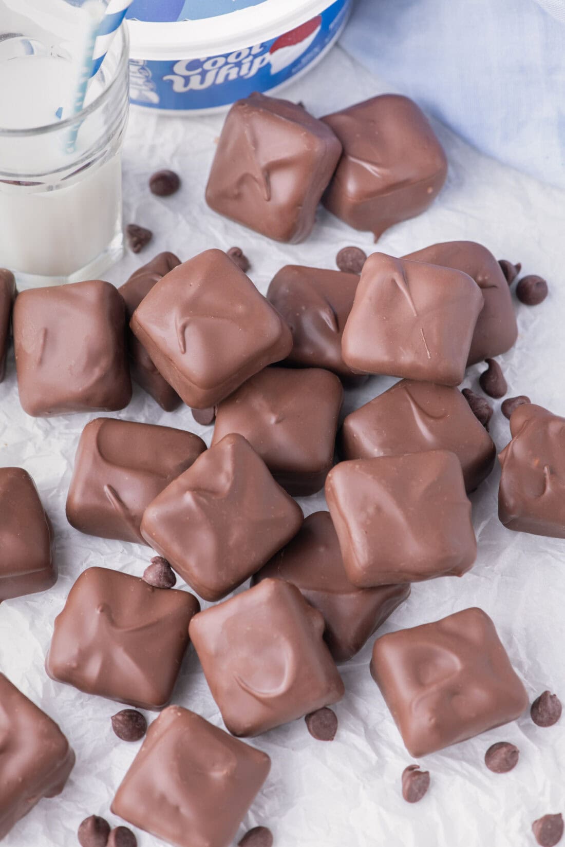 Cool Whip Candy scattered on a table with chocolate chips