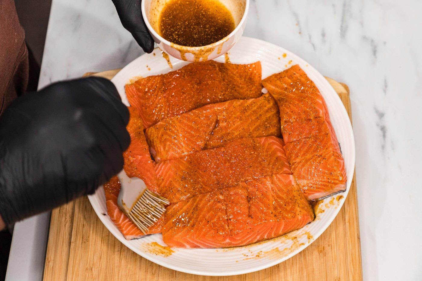 basting salmon filets with olive oil and seasonings