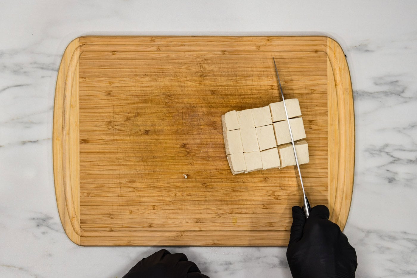 slicing tofu into cubes