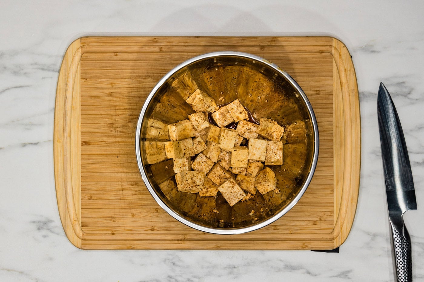 seasoned tofu cubes in a mixing bowl