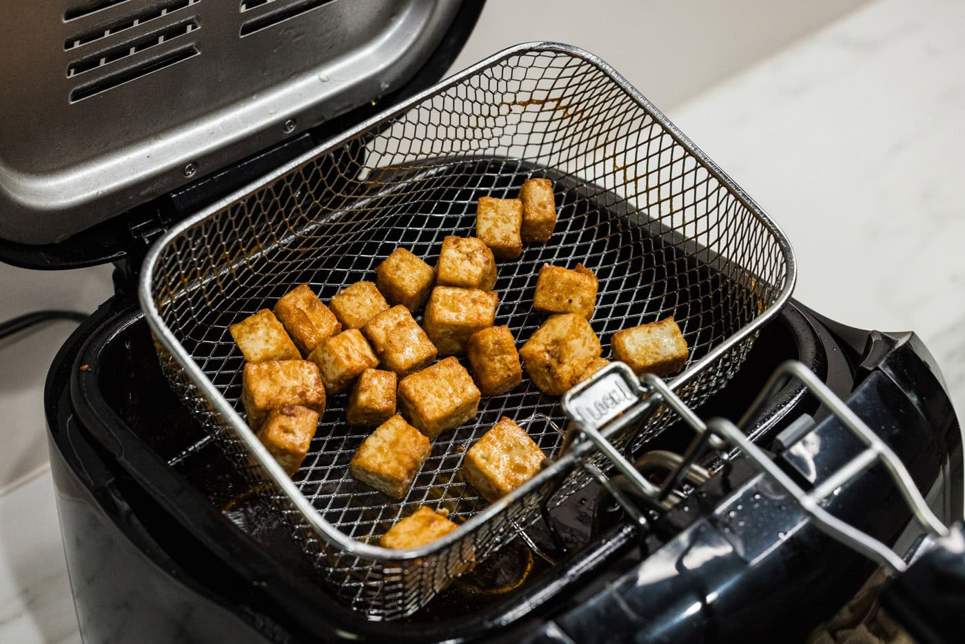 deep fried tofu in fryer basket