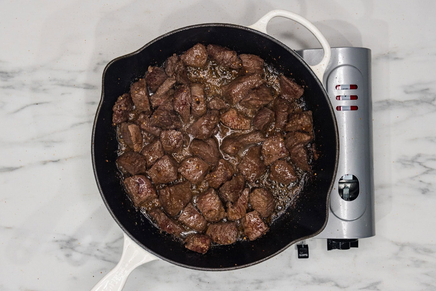 cooked cubed steak in a skillet