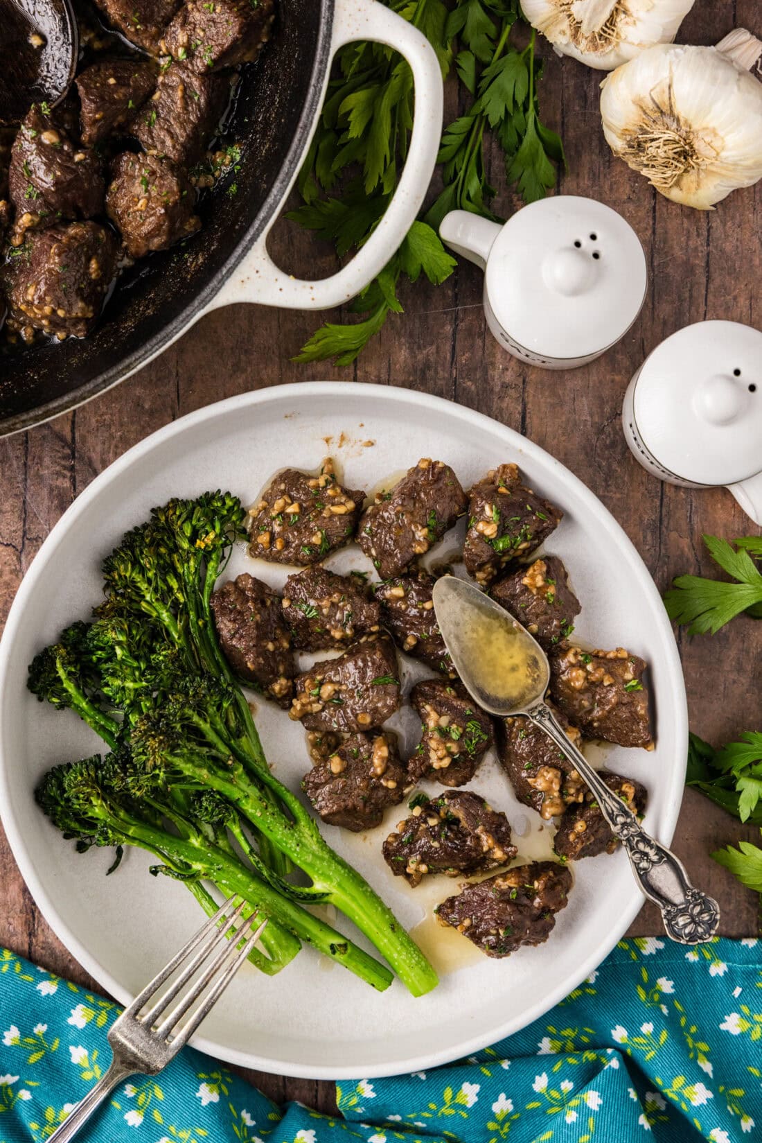 Garlic Butter Steak Bites on a plate with broccolini 