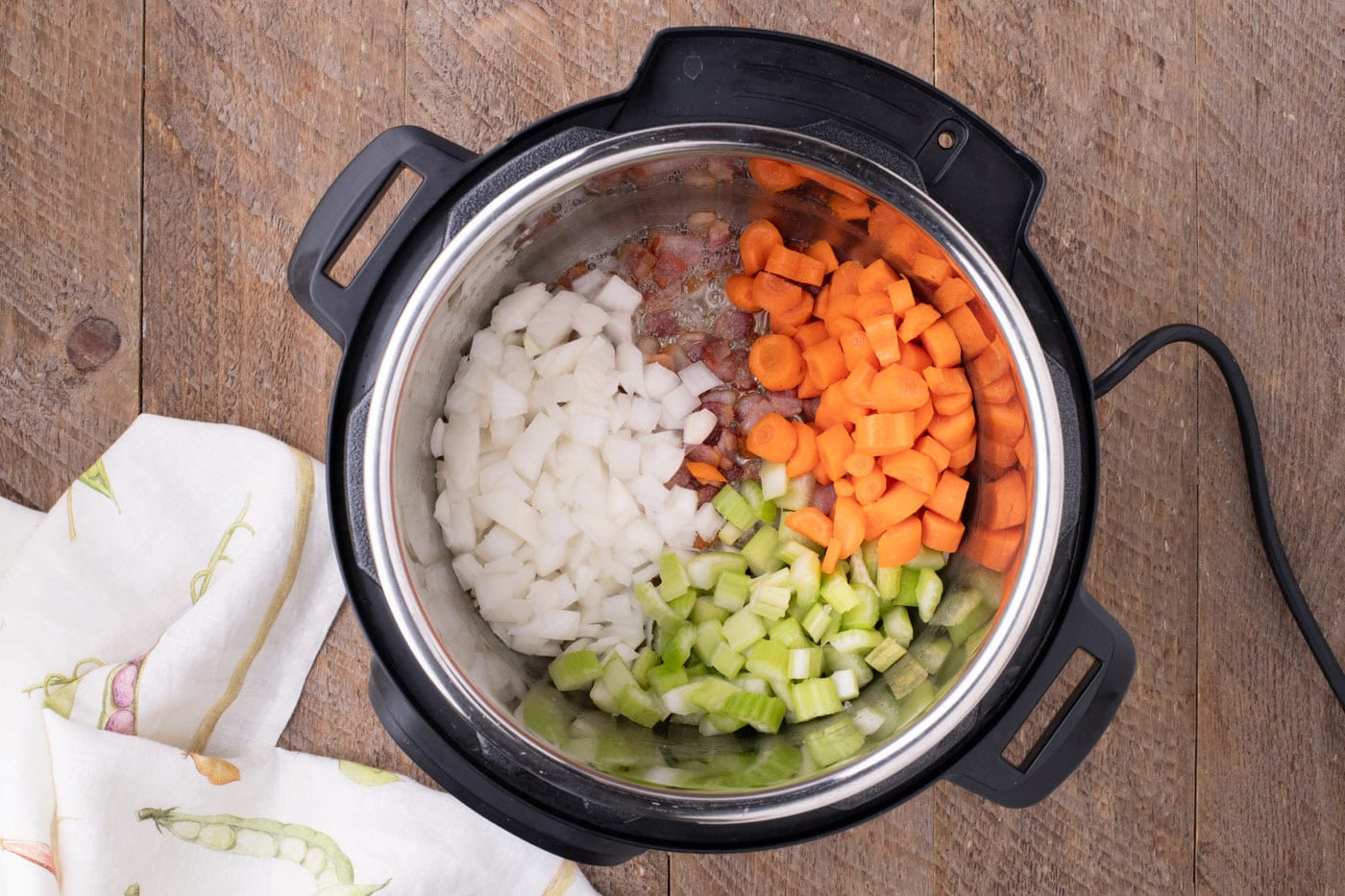 onions, carrots, and celery added to bacon in the instant pot