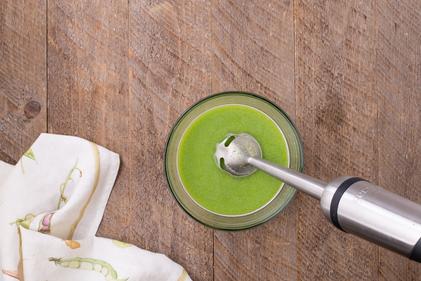 split peas and broth blitzed in a bowl with an immersion blender