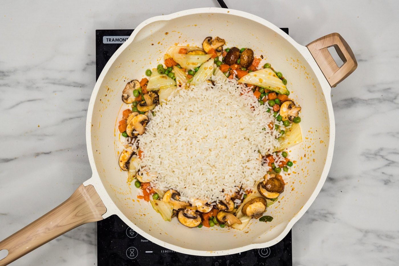 rice added to skillet with stir fried veggies