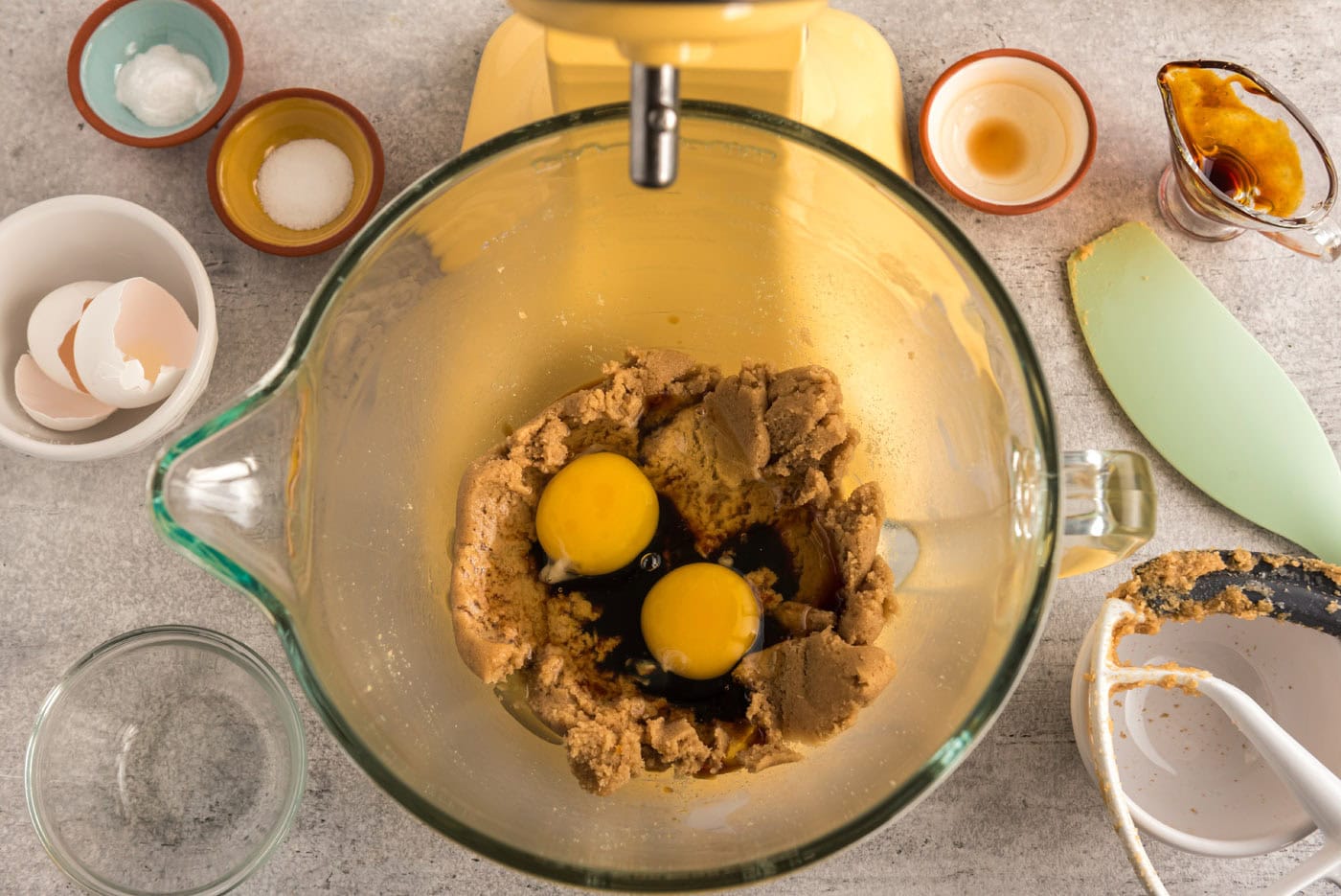 eggs and molasses added to sugar mixture in a stand mixer bowl