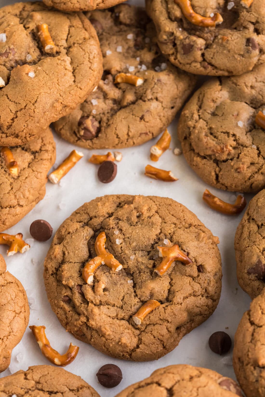 Close up photo of Pretzel Chocolate Chip Cookies scattered on a table