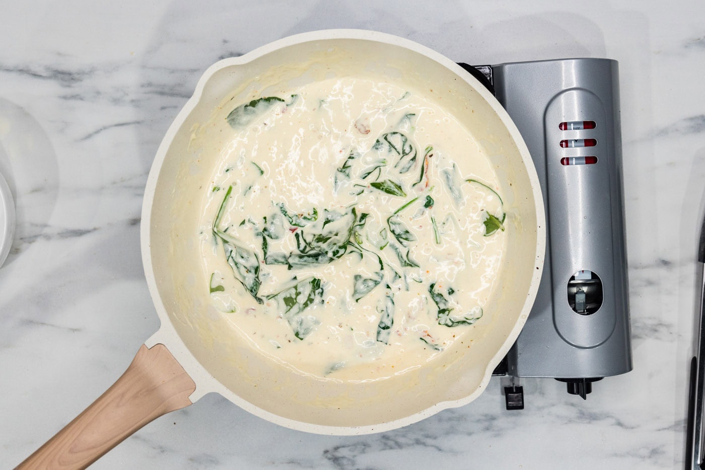 spinach in cream sauce in a skillet